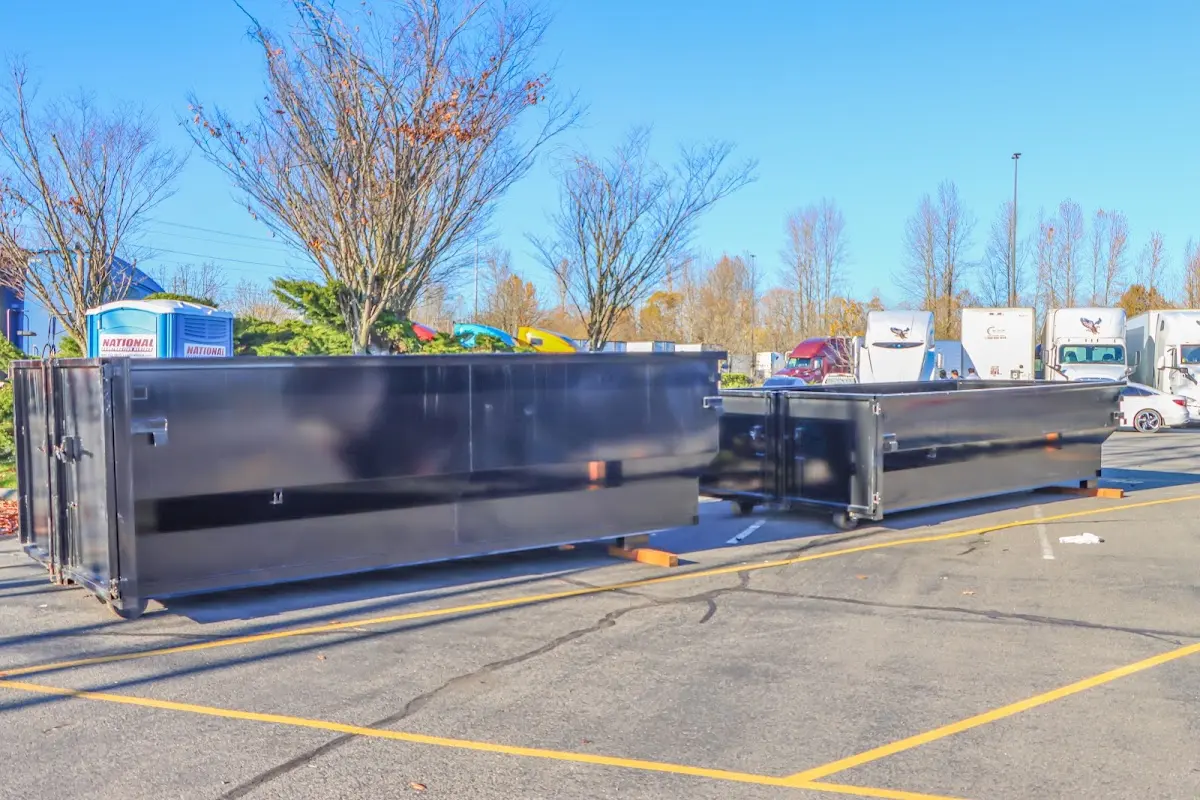 Professional dumpster rental service with roll-off container on residential driveway in Walla Walla